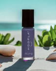 Newport Love - Clean Nail Polish bottle in purple shade displayed outdoors with shells and green leaves, highlighting vegan clean beauty nail polish by HOOPLA.