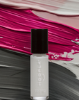 Small white nail polish bottle with black cap labeled Hoopla placed on a textured background of pink, beige, gray, and white brush strokes, promoting Angelic Arrow - Clean Nail Polish.