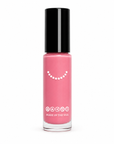 A bottle of Zinnia - Clean Nail Polish in a soft pink shade with a black cap, featuring clean beauty certification icons on the front.
