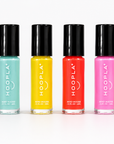 Six vibrant mini nail polish bottles in bright pink, turquoise, yellow, coral, light pink, and green colors, labeled HOOPLA, showcasing the Pocket Polish Set - Sun+Sand for clean, vegan nail treatments.